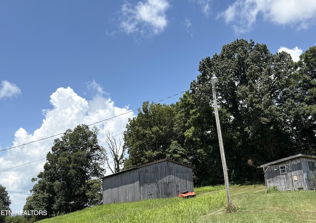 1370 Raven Hill Rd, Tazewell, TN 37879 - view of green lawn featuring a storage unit