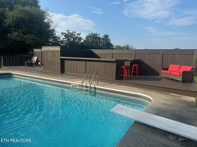 8024 Sharp Rd, Powell, TN 37849 - view of swimming pool featuring a diving board and a wooden deck