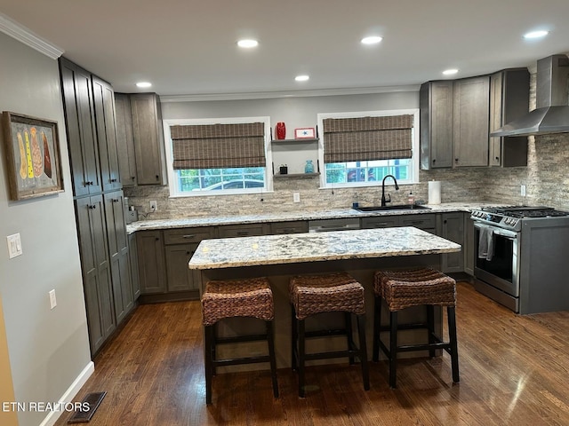 8024 Sharp Rd, Powell, TN 37849 - kitchen featuring wall chimney exhaust hood, stainless steel gas range, crown molding, decorative backsplash, and light stone counters