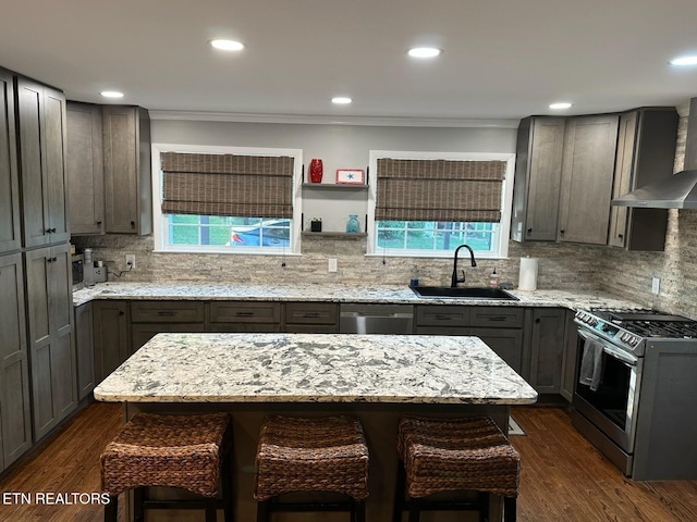 8024 Sharp Rd, Powell, TN 37849 - kitchen with appliances with stainless steel finishes, healthy amount of natural light, a kitchen breakfast bar, dark wood-style flooring, and ornamental molding