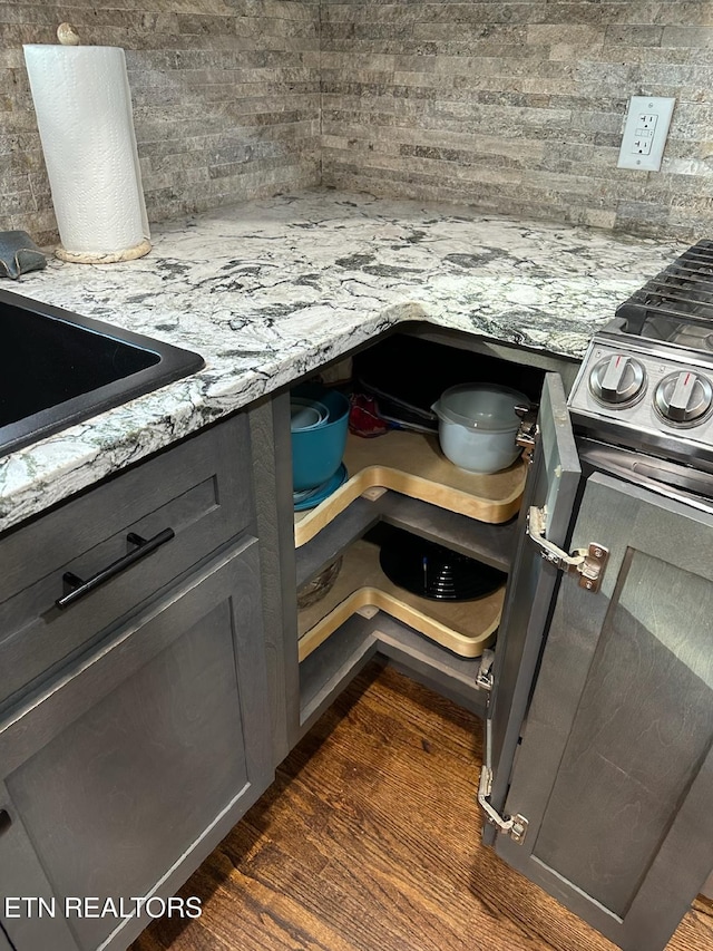 8024 Sharp Rd, Powell, TN 37849 - kitchen view of stove, decorative backsplash, light stone counters, and dark wood-style floors