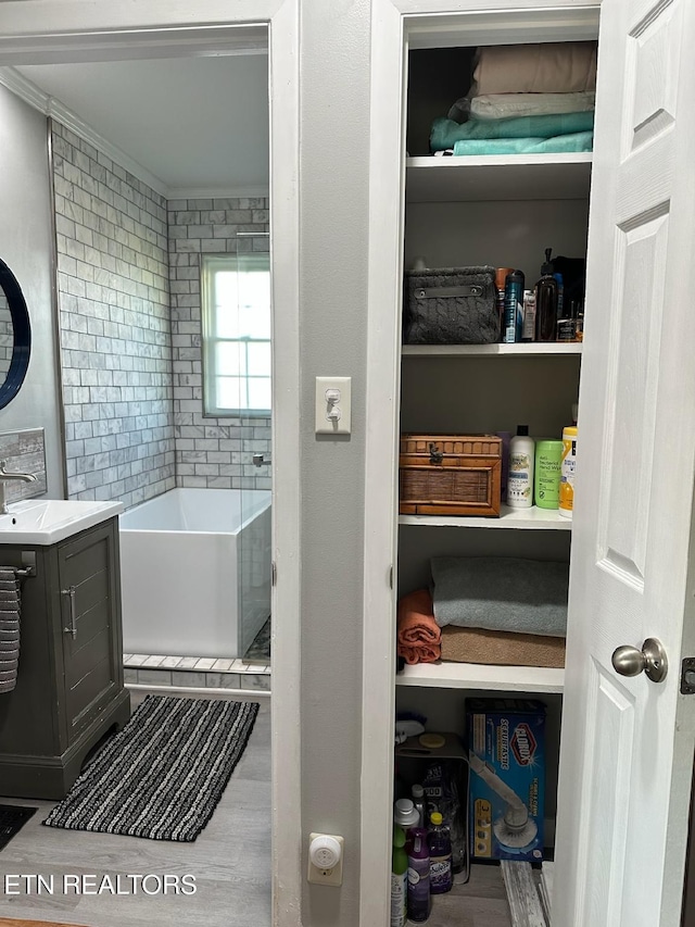 8024 Sharp Rd, Powell, TN 37849 - full bathroom with vanity, a tub to relax in, wood finished floors, and crown molding
