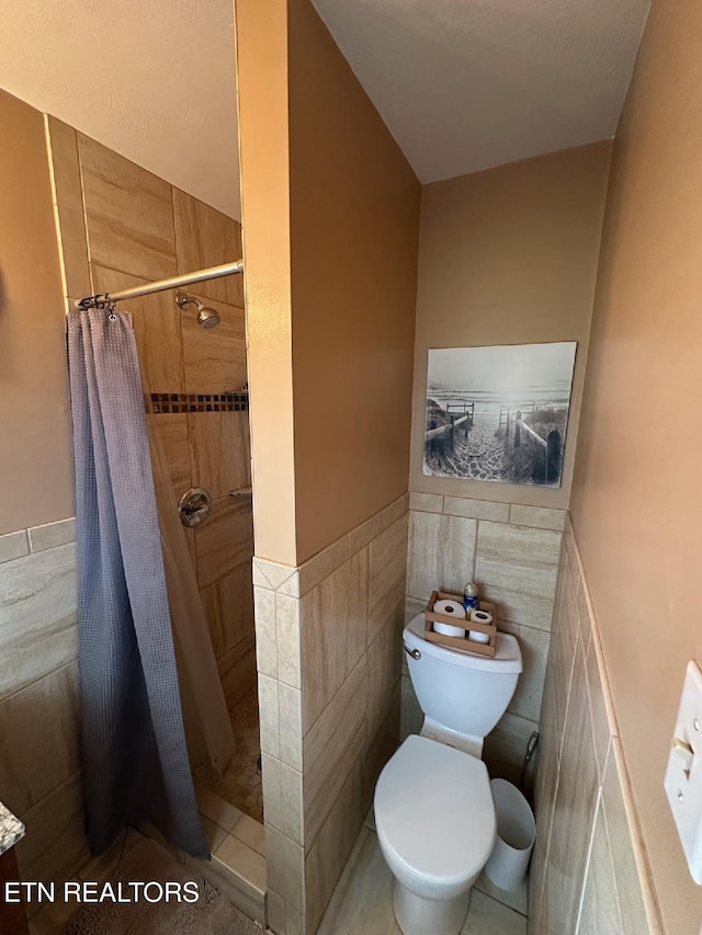 8024 Sharp Rd, Powell, TN 37849 - full bath with tile walls, a shower stall, and a wainscoted wall