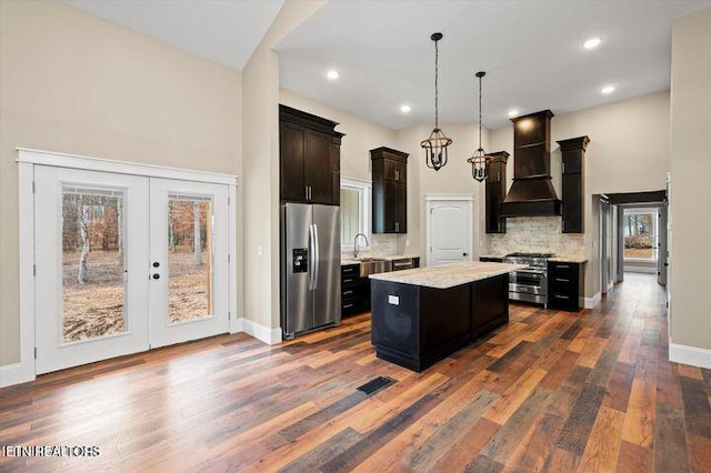 455 Sunset Harbor Dr, Dandridge, TN 37725 - kitchen featuring appliances with stainless steel finishes, custom range hood, decorative backsplash, dark wood-style floors, and a kitchen island
