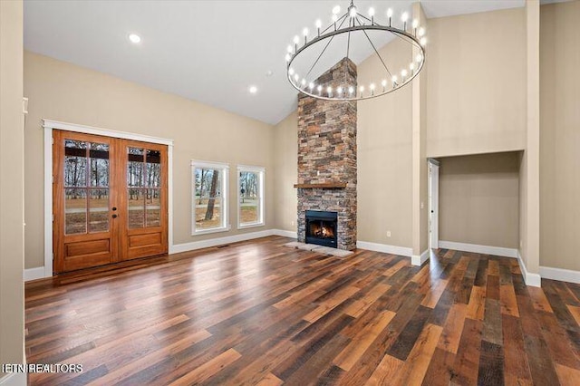 455 Sunset Harbor Dr, Dandridge, TN 37725 - unfurnished living room with a chandelier, high vaulted ceiling, wood finished floors, a fireplace, and french doors