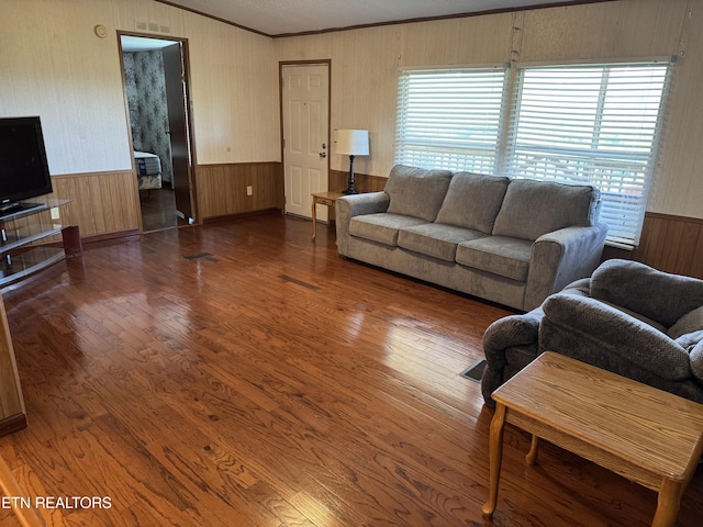 Ousley Crst, Cumberland Gap, TN 37724 - living area featuring wood walls, healthy amount of natural light, a wainscoted wall, wood finished floors, and crown molding