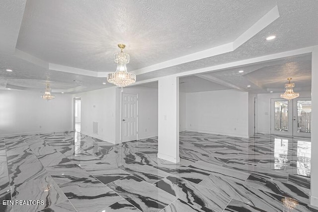 1220 Ariell Lea, Sevierville, TN 37862 - unfurnished living room with a chandelier, a raised ceiling, a textured ceiling, recessed lighting, and french doors