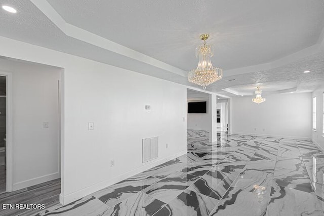 1220 Ariell Lea, Sevierville, TN 37862 - spare room featuring a raised ceiling, a chandelier, and recessed lighting