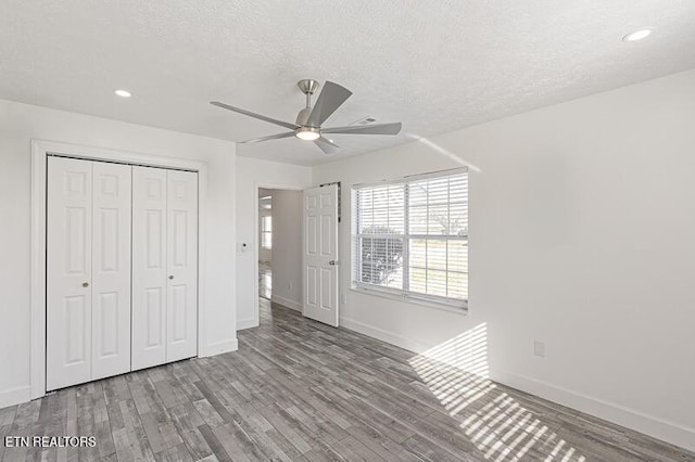 1220 Ariell Lea, Sevierville, TN 37862 - unfurnished bedroom with wood finished floors, a closet, recessed lighting, a textured ceiling, and a ceiling fan