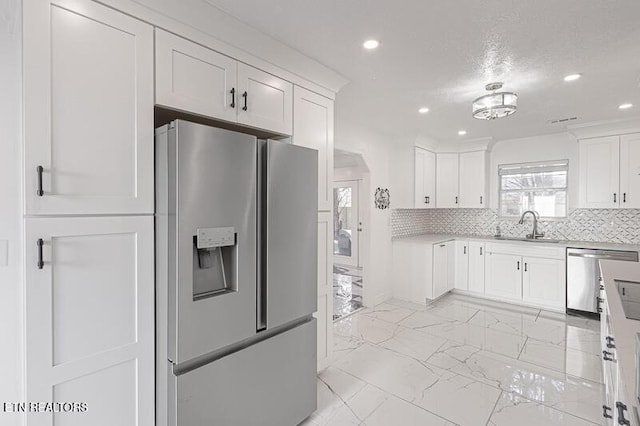 1220 Ariell Lea, Sevierville, TN 37862 - kitchen featuring stainless steel appliances, recessed lighting, white cabinets, light marble finish flooring, and light countertops