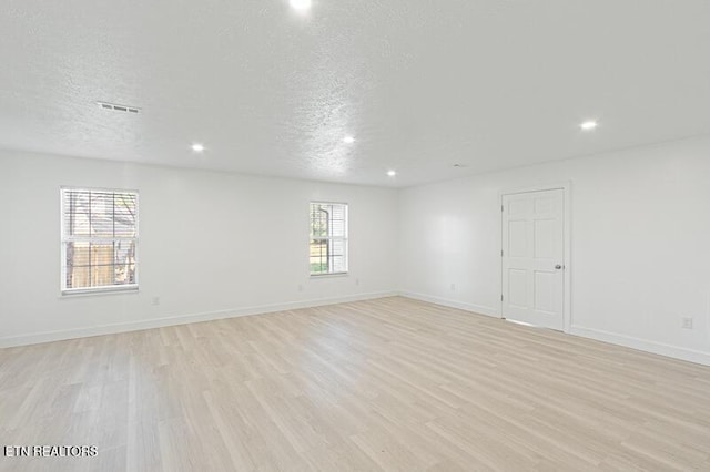 1220 Ariell Lea, Sevierville, TN 37862 - empty room with light wood-style floors, recessed lighting, and a textured ceiling