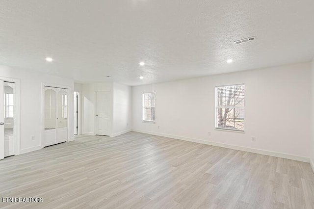 1220 Ariell Lea, Sevierville, TN 37862 - unfurnished room featuring healthy amount of natural light, light wood finished floors, recessed lighting, and a textured ceiling