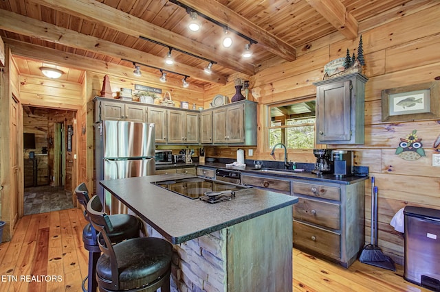 3012 Oak Tree Way, Pigeon Forge, TN 37863 - kitchen featuring light wood-style floors, freestanding refrigerator, dark countertops, rail lighting, and a wood ceiling with exposed beams