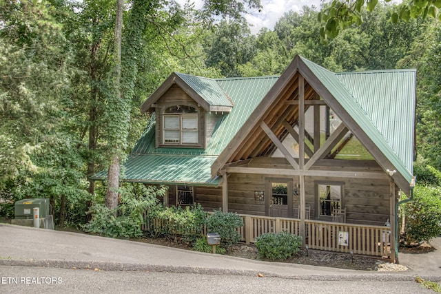 3012 Oak Tree Way, Pigeon Forge, TN 37863 - rustic home featuring covered porch, a metal roof, and view of wooded area