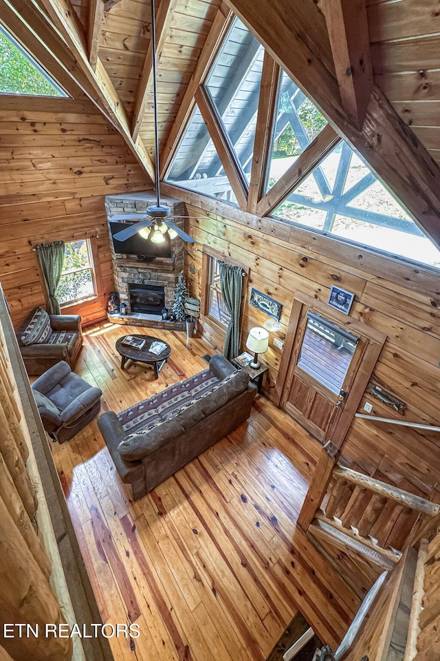 3012 Oak Tree Way, Pigeon Forge, TN 37863 - living area with wooden walls, hardwood / wood-style floors, a ceiling fan, a stone fireplace, and wooden ceiling