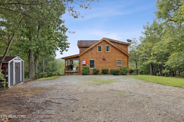 1818 Saddle Way, Sevierville, TN 37876 - view of front of house with a storage shed, gravel driveway, and a wooden deck