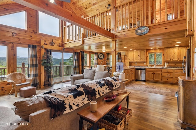 1818 Saddle Way, Sevierville, TN 37876 - living room featuring healthy amount of natural light, high vaulted ceiling, light wood finished floors, a mountain view, and wooden walls