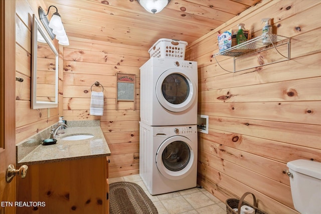 1818 Saddle Way, Sevierville, TN 37876 - laundry room featuring estacked washer and dryer, wood ceiling, wooden walls, and light tile patterned floors