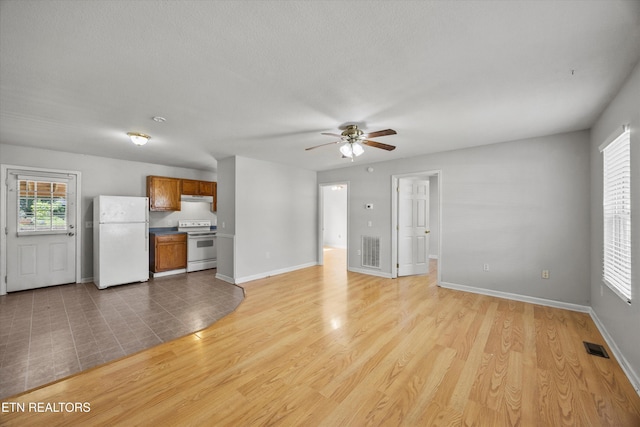 710 E Fir St, Lafollette, TN 37766 - unfurnished living room with ceiling fan and light wood-style flooring