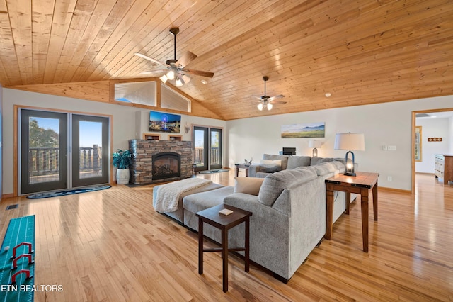 836 Sandra Way, Kodak, TN 37764 - living area featuring wood ceiling, vaulted ceiling, light wood-type flooring, a ceiling fan, and a stone fireplace