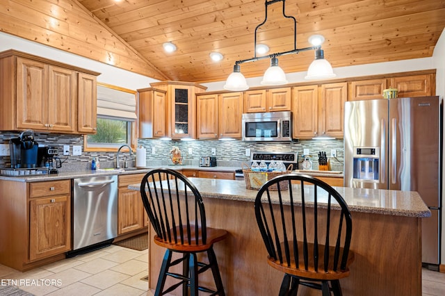 836 Sandra Way, Kodak, TN 37764 - kitchen featuring appliances with stainless steel finishes, lofted ceiling, wood ceiling, a kitchen island, and backsplash