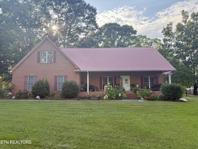 1750 Breezie Point Ln, Dandridge, TN 37725 - view of front of property with brick siding, a porch, a front lawn, and a metal roof