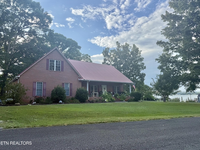 1750 Breezie Point Ln, Dandridge, TN 37725 - view of front facade with brick siding, a front lawn, and a metal roof