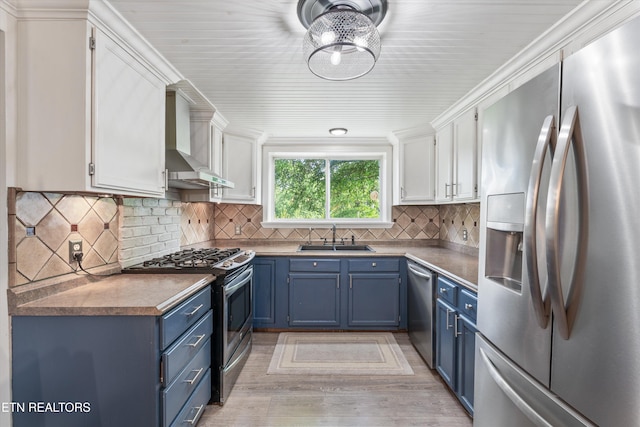 976 Lone Rd, Pioneer, TN 37847 - kitchen with stainless steel appliances, blue cabinetry, wall chimney exhaust hood, and white cabinets