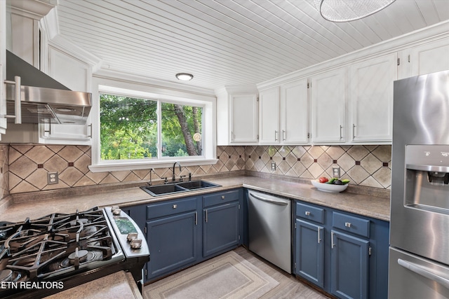 976 Lone Rd, Pioneer, TN 37847 - kitchen with stainless steel appliances, blue cabinetry, white cabinets, backsplash, and exhaust hood