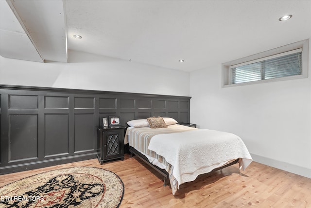 976 Lone Rd, Pioneer, TN 37847 - bedroom with light wood-style flooring, recessed lighting, and a decorative wall