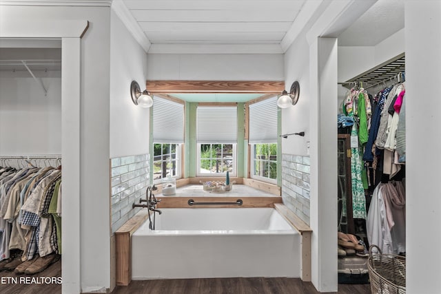 976 Lone Rd, Pioneer, TN 37847 - full bathroom with crown molding, a garden tub, a walk in closet, and wood finished floors