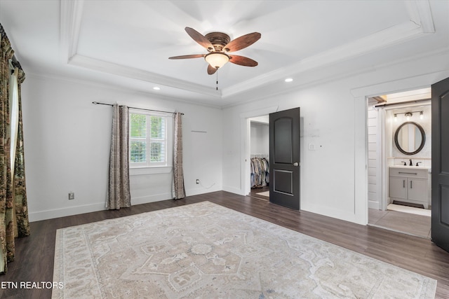 976 Lone Rd, Pioneer, TN 37847 - unfurnished bedroom featuring a raised ceiling, ornamental molding, wood finished floors, a walk in closet, and connected bathroom