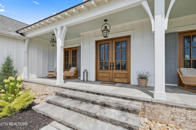 1014 High Springs Rd, Knoxville, TN 37932 - view of exterior entry featuring french doors, a porch, board and batten siding, and roof with shingles