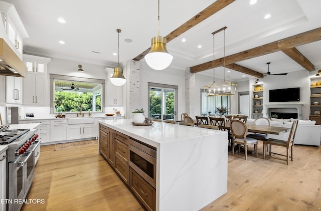 1014 High Springs Rd, Knoxville, TN 37932 - kitchen featuring appliances with stainless steel finishes, beam ceiling, a ceiling fan, white cabinets, and light wood finished floors