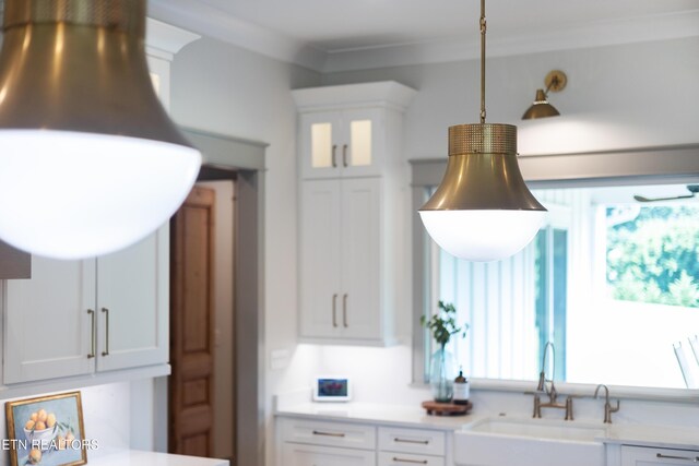 1014 High Springs Rd, Knoxville, TN 37932 - kitchen view of white cabinets, light countertops, pendant lighting, ornamental molding, and glass insert cabinets