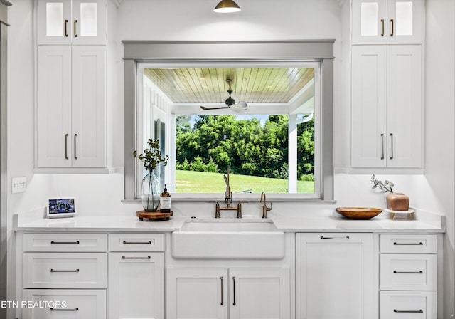 1014 High Springs Rd, Knoxville, TN 37932 - kitchen featuring white cabinets, light countertops, a ceiling fan, and glass insert cabinets