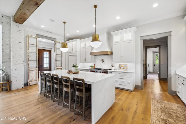 1014 High Springs Rd, Knoxville, TN 37932 - kitchen with custom exhaust hood, plenty of natural light, light countertops, light wood-type flooring, and ornamental molding