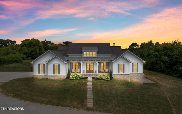 1014 High Springs Rd, Knoxville, TN 37932 - modern inspired farmhouse featuring french doors, a standing seam roof, board and batten siding, and a porch