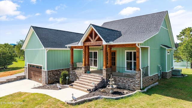 487 Peninsula, Rutledge, TN 37861 - view of front of property with a porch, roof with shingles, a front yard, driveway, and an attached garage