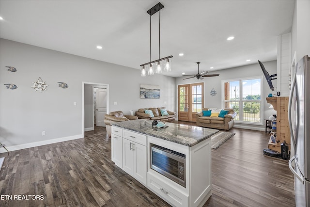 487 Peninsula, Rutledge, TN 37861 - kitchen with appliances with stainless steel finishes, open floor plan, white cabinetry, stone counters, and dark wood-style flooring