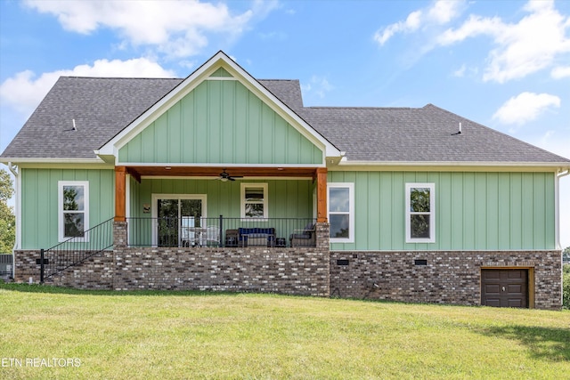 487 Peninsula, Rutledge, TN 37861 - view of front of home featuring a ceiling fan, a shingled roof, a front yard, board and batten siding, and brick siding
