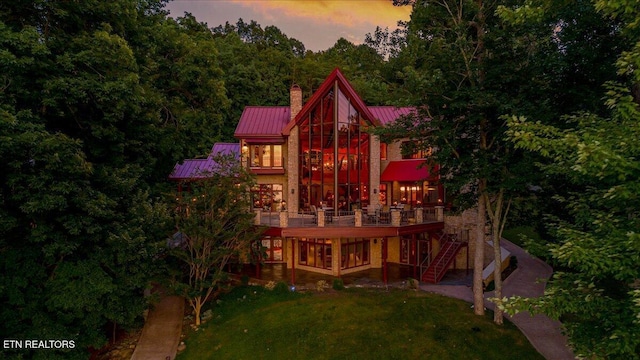311 Deerwood Ln, Lafollette, TN 37766 - rear view of property with a chimney, a lawn, a metal roof, stairs, and a wooden deck