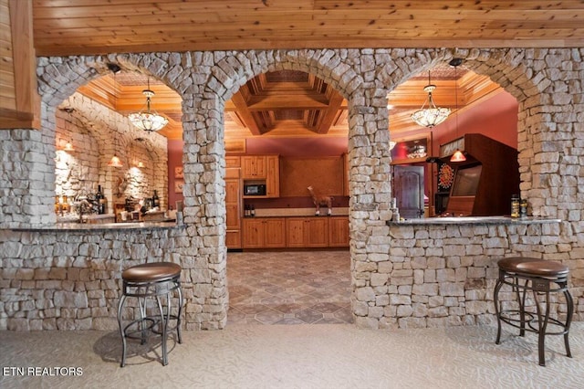 311 Deerwood Ln, Lafollette, TN 37766 - bar with a chandelier, black microwave, a wood ceiling with exposed beams, decorative columns, and hanging light fixtures