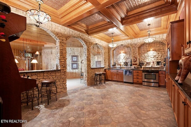 311 Deerwood Ln, Lafollette, TN 37766 - kitchen with a chandelier, stainless steel appliances, brown cabinets, dark countertops, and ornamental molding