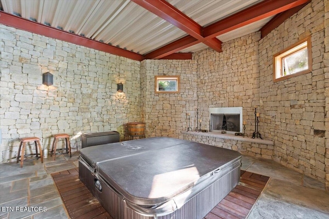 311 Deerwood Ln, Lafollette, TN 37766 - rec room with beam ceiling, exterior fireplace, and stone finish floors