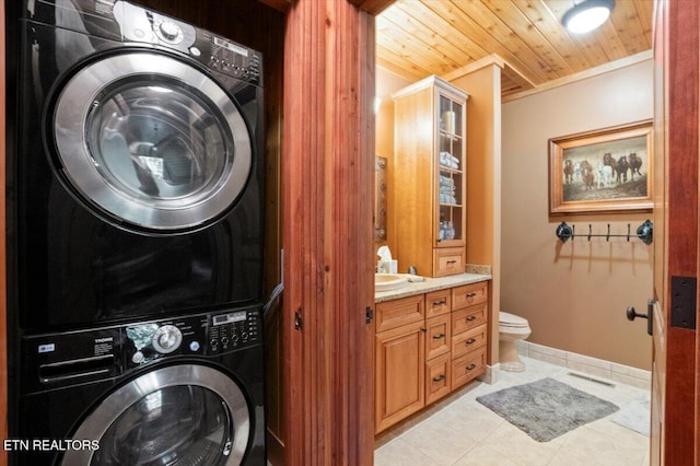 311 Deerwood Ln, Lafollette, TN 37766 - washroom featuring stacked washer / dryer, wooden ceiling, and light tile patterned floors