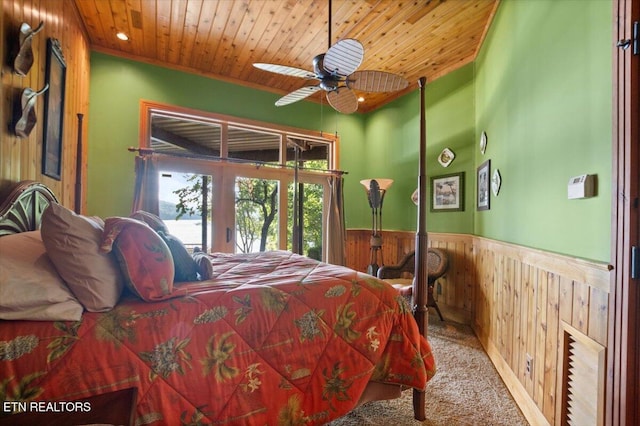 311 Deerwood Ln, Lafollette, TN 37766 - bedroom with wooden walls, french doors, wood ceiling, a wainscoted wall, and carpet flooring