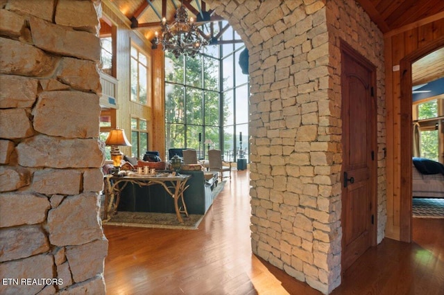 311 Deerwood Ln, Lafollette, TN 37766 - corridor with high vaulted ceiling, hardwood / wood-style flooring, a wooden ceiling with exposed beams, and a chandelier