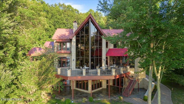 311 Deerwood Ln, Lafollette, TN 37766 - back of property featuring a metal roof, a chimney, a deck, and a standing seam roof