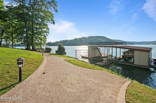 311 Deerwood Ln, Lafollette, TN 37766 - dock featuring boat lift, a water view, and a lawn